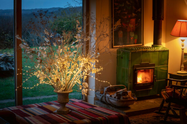 Arrangement of sprayed and faux honesty, fennel and Allium schubertii in a cement urn